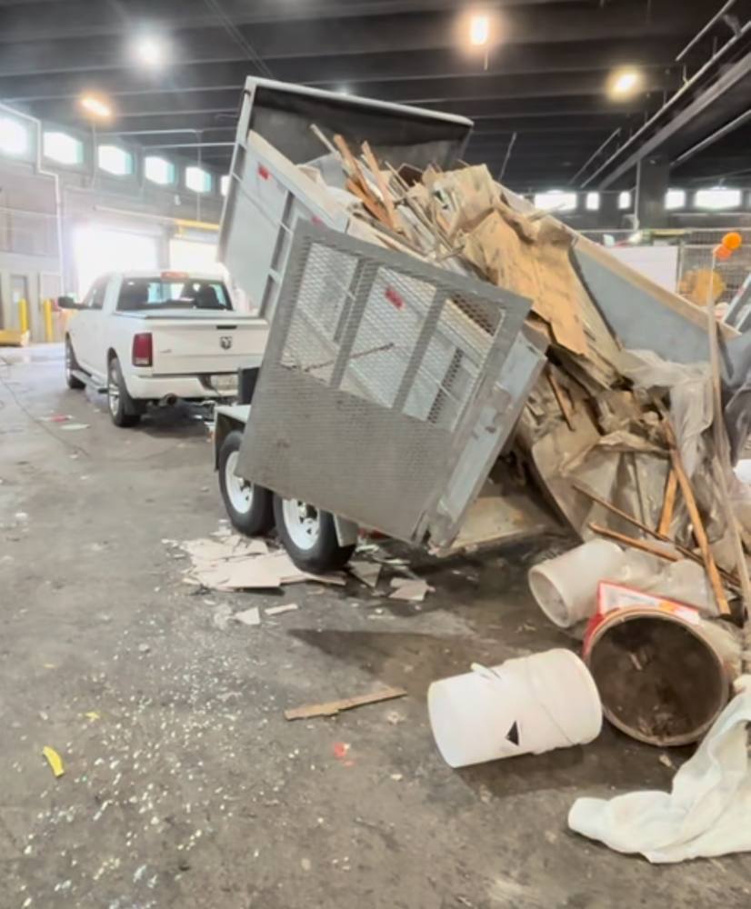 Dump trailer unloading renovation debris at a disposal facility